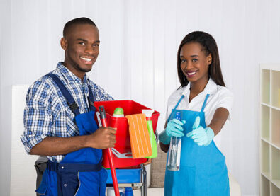 Portrait Of Happy African Male And Female Janitors