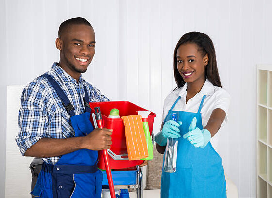 Portrait Of Happy African Male And Female Janitors